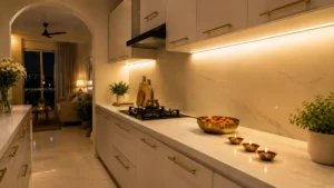 A modular kitchen with warm white cabinets decorated for Diwali with diyas and marigold flowers on the counter