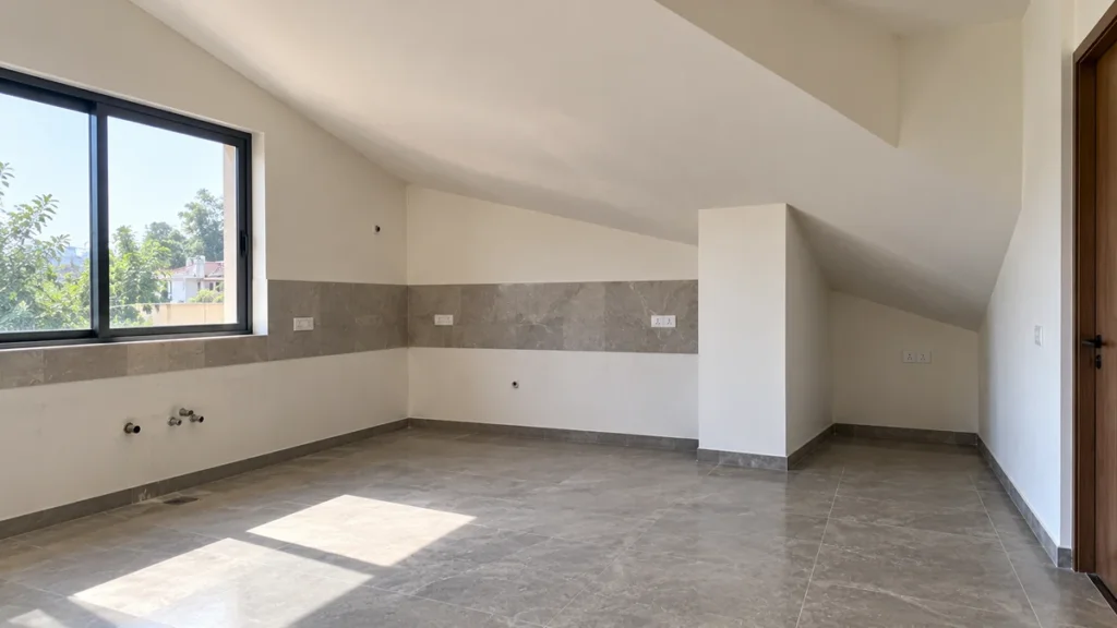Irregularly shaped kitchen space with a sloped ceiling and awkward corner that standard modules cannot fit